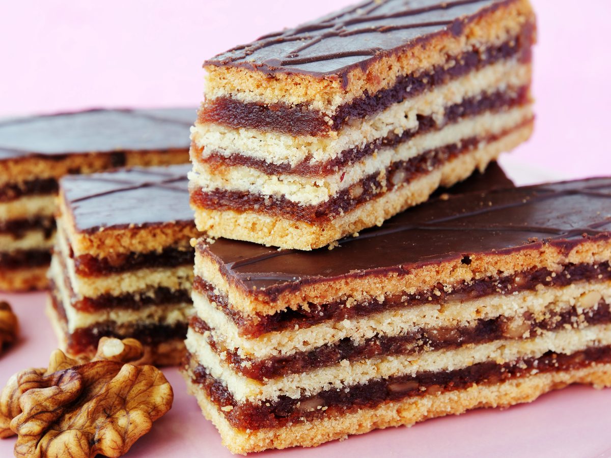 Squares of zserbó, layered walnut and apricot cake with chocolate glaze