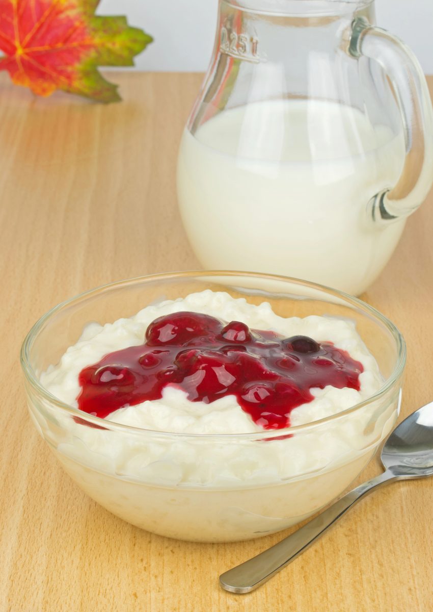 Bowl of rice cream topped with red berry sauce