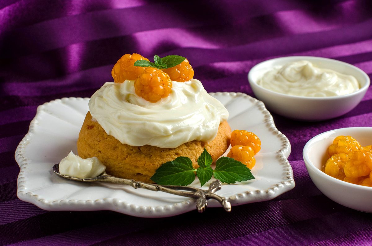 Cloudberry cream dessert with whipped cream and yellow cloudberries