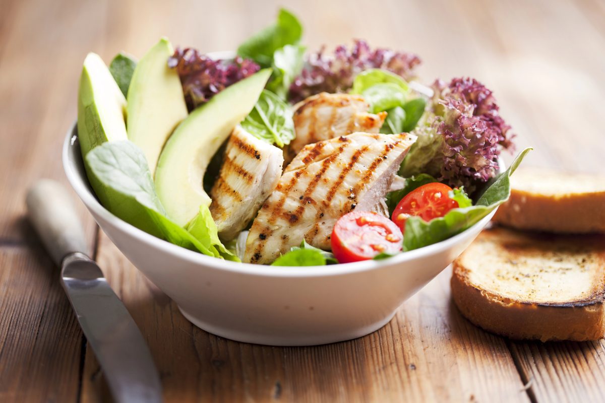 Chicken salad with avocado, tomatoes and toasted bread