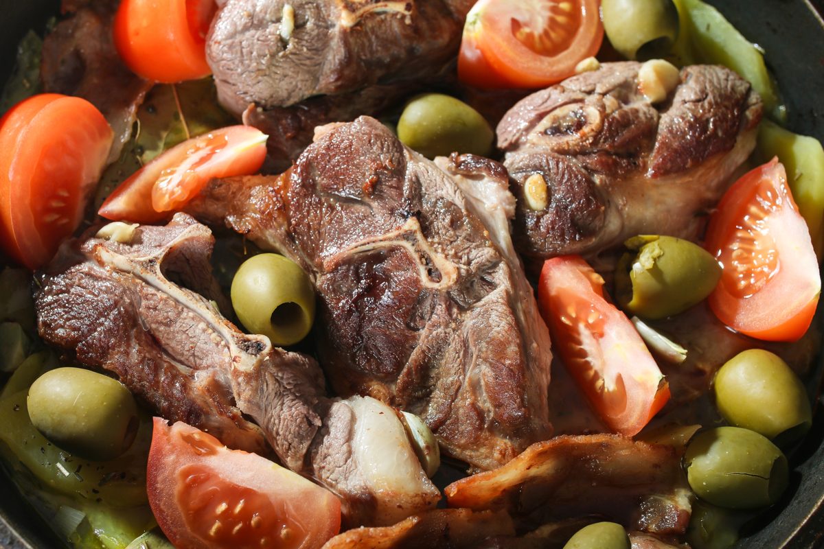 Roast lamb with potatoes, tomatoes and olives