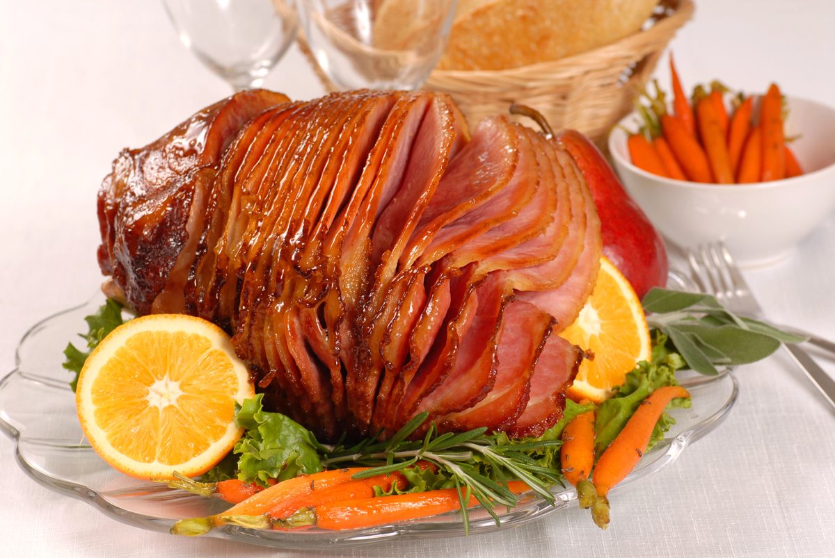 Glazed Easter ham with orange slices and carrots