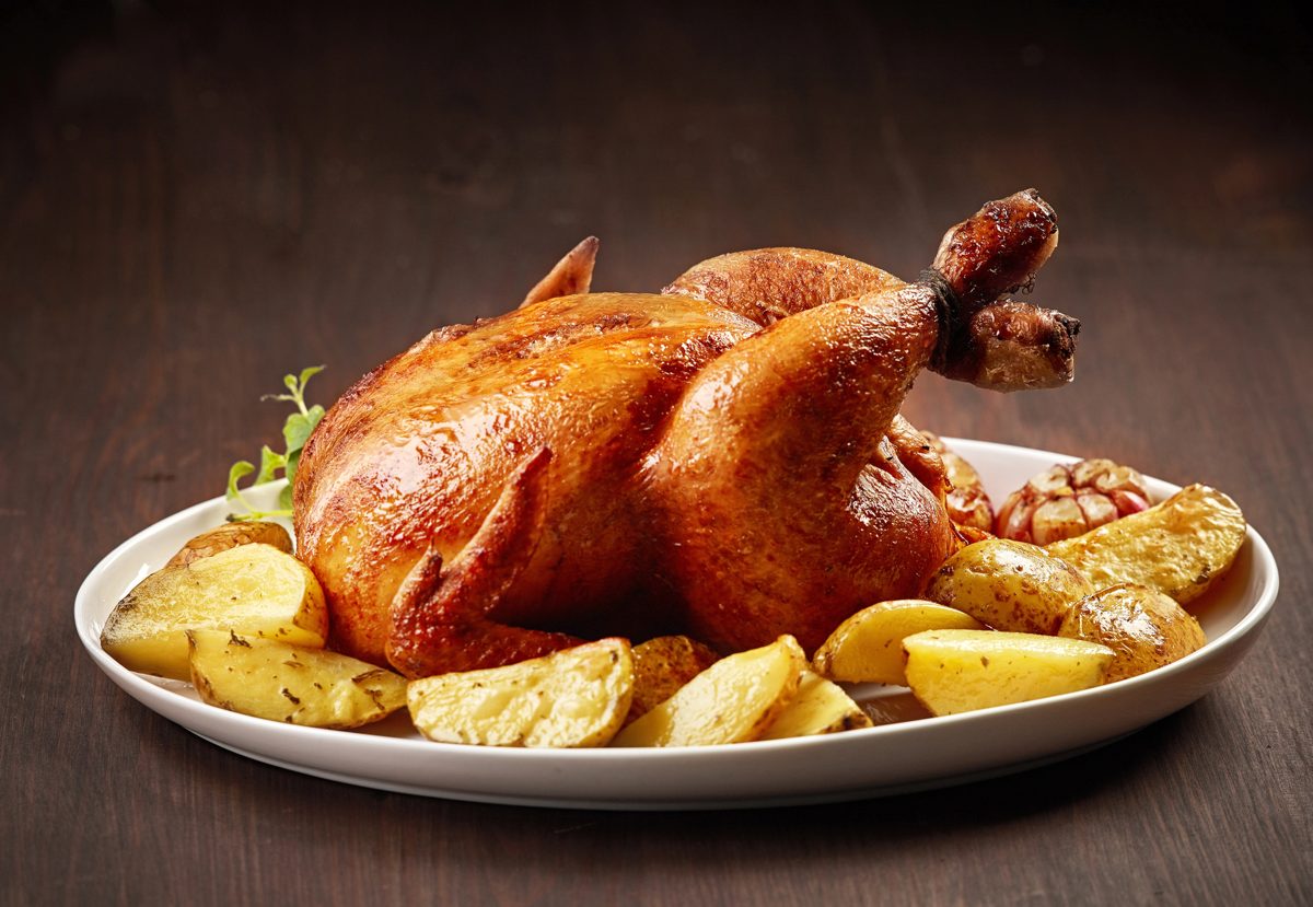 Roast chicken with roasted potatoes on a platter