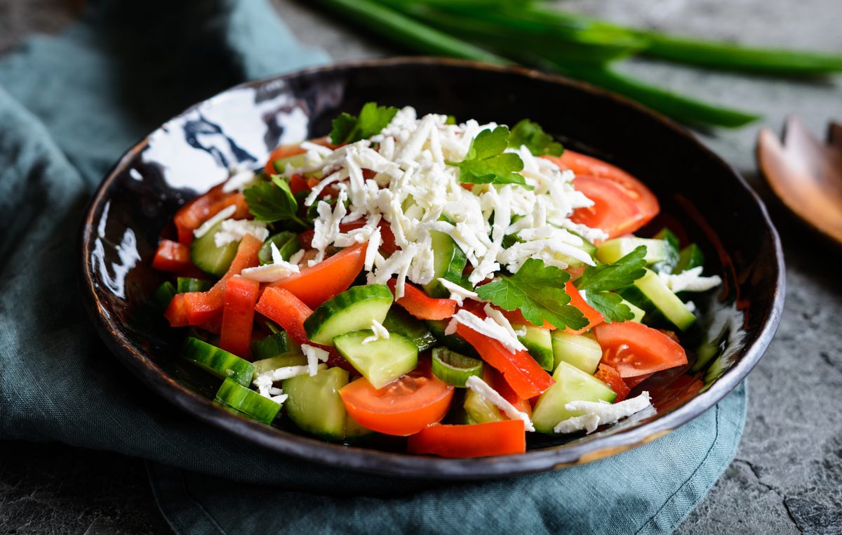 Shopska salad with tomato, cucumber, pepper and grated white cheese