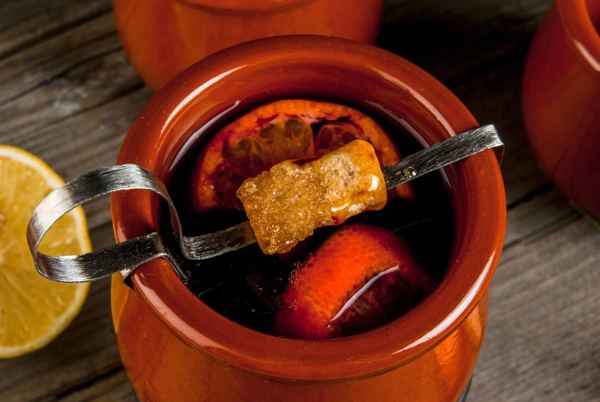 Feuerzangenbowle: a rum-soaked sugar cone on tongs above a pot of hot red wine punch