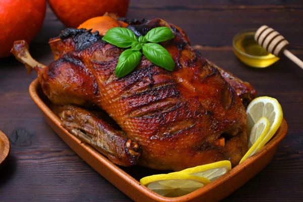 Whole roast duck on a rustic table