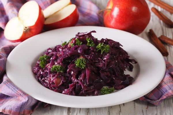 Braised red cabbage with apples on a white plate