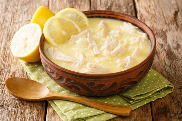 Avgolemono chicken soup with lemon slices in a bowl