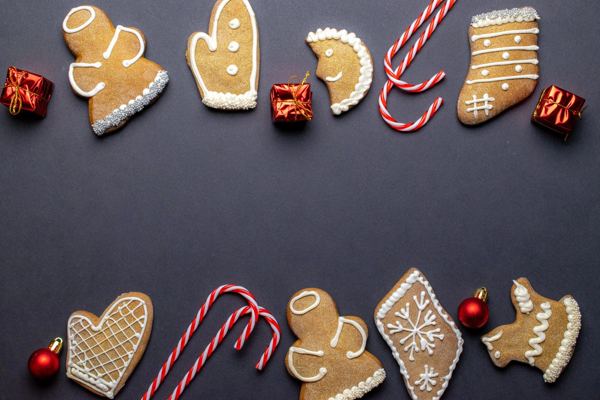 Iced gingerbread medenjaci cookies in festive shapes on a dark background