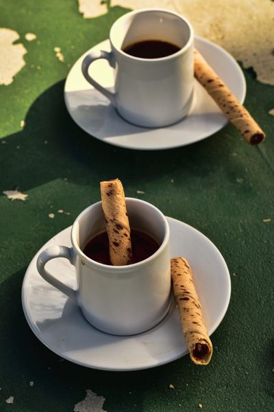 Rolled krumkake wafer cookies served with cups of coffee