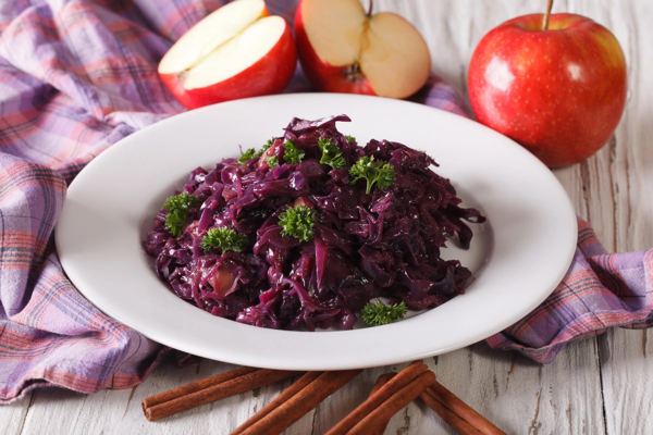 Braised red cabbage with apples on a white plate