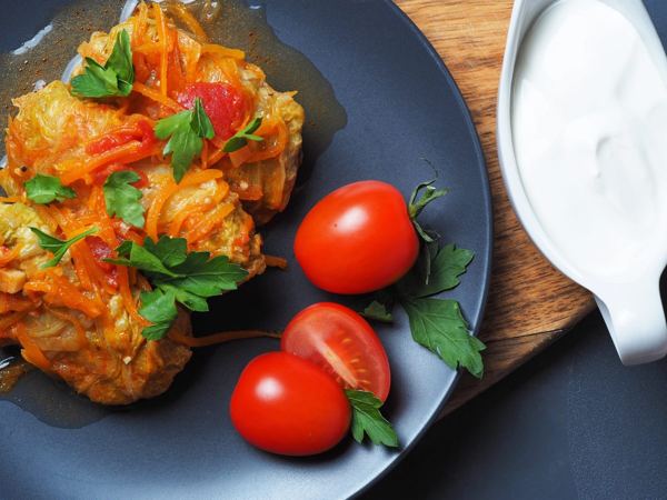Holubtsi cabbage rolls in tomato sauce with fresh tomatoes