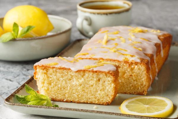 Glazed lemon cake with lemon zest and lemon slices
