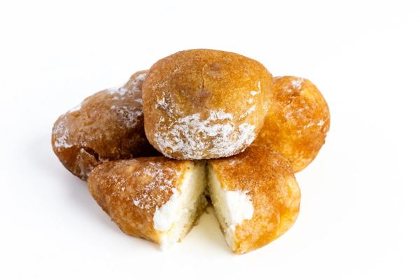 Buñuelos de viento, cream-filled fritters dusted with sugar