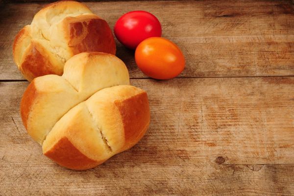 Pinca, Croatian sweet Easter bread with a cross cut, next to red eggs