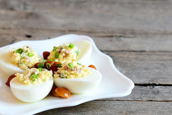 Stuffed egg halves on a white plate