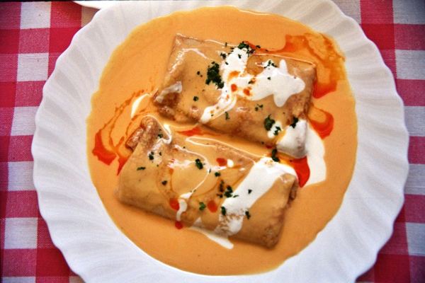 Meat-filled crepes in paprika cream sauce with sour cream
