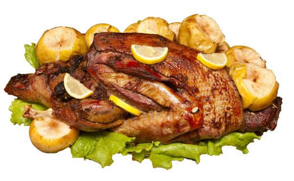 Roast duck with apples and lemon on a platter