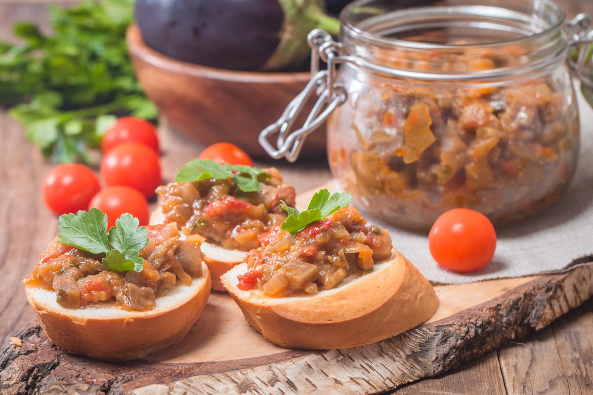 Eggplant caviar in a glass jar and on toasted bread